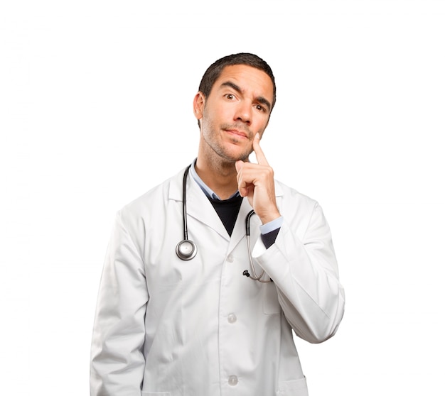 Suspicious doctor against white background