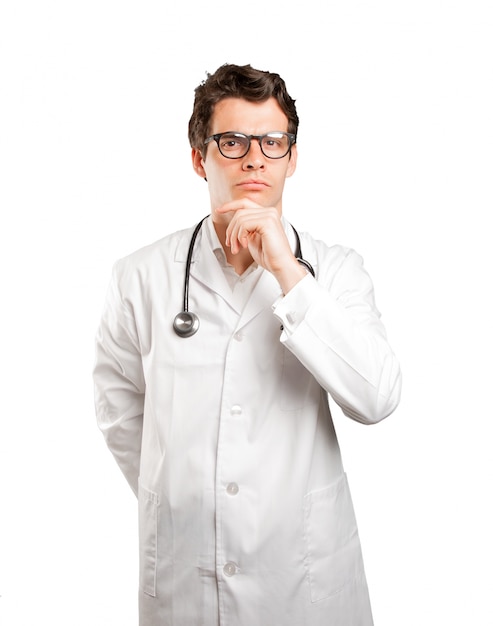 Suspicious doctor against white background