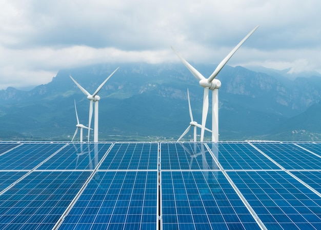 Sustainable clean energy solar panel and wind turbines closeup