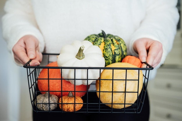 Sustainable eco friendly slow living thanksgiving various thanksgiving pumpkins in metal basket in