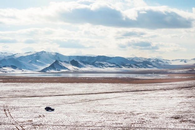 SUV car on a slippery winter dirt road in the steppe