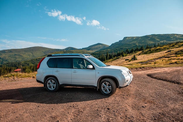 Suv car on the top of ukraine carpathian mountain range