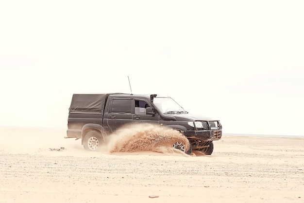 SUV in the desert / old vintage all-terrain vehicle, expedition in the desert on the sand, extreme cars