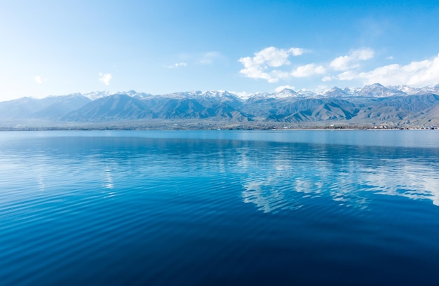 Sverny shore of Lake IssykKul Kyrgyzstan View from the ship to the shore Blue water of a mountain lake