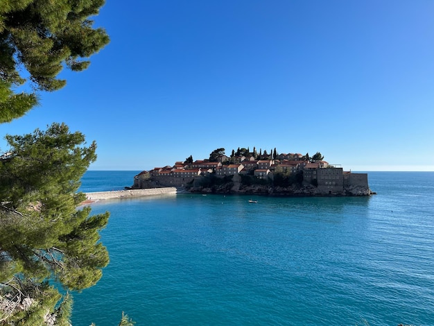 Sveti Stefan island against the blue sky and the sea Montenegro