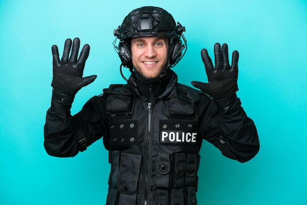 SWAT caucasian man isolated on blue background counting ten with fingers