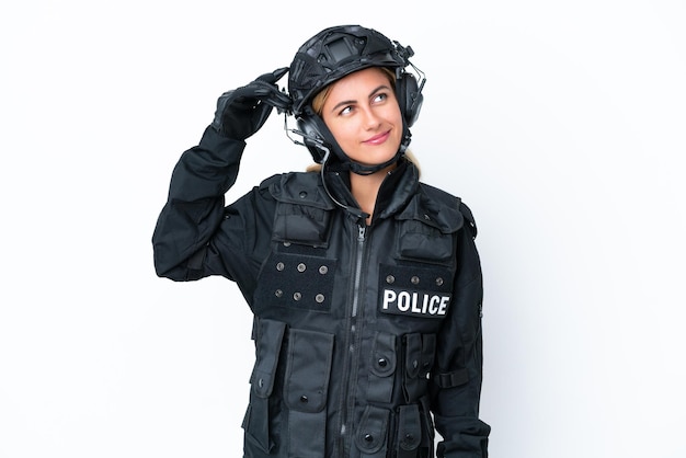 SWAT caucasian woman isolated on white background having doubts and with confuse face expression