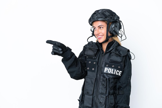 SWAT caucasian woman isolated on white background pointing finger to the side and presenting a product