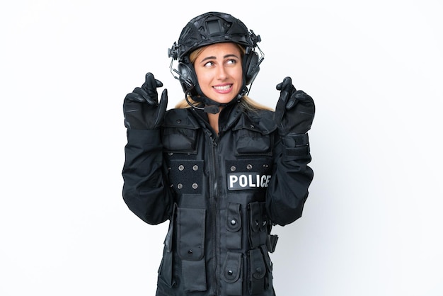 SWAT caucasian woman isolated on white background with fingers crossing