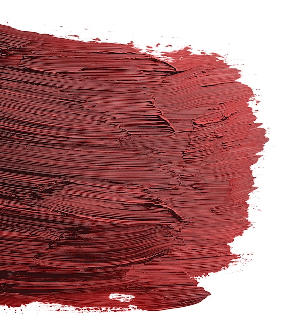 Swatch of red smudged acrylic paint isolated on white background, close up