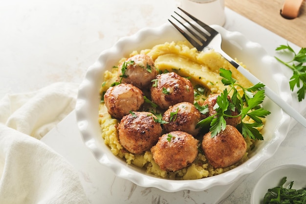 Swedish meatballs in cream sauce potatoes and lingonberry sauce in bowl on slate stone or concrete backgrounds Swedish cuisine Delicious creamy mashed potatoes Top view