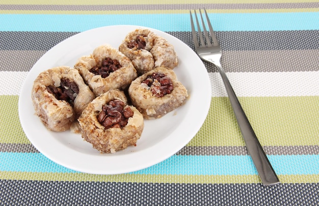 Sweet baklava on plate on table