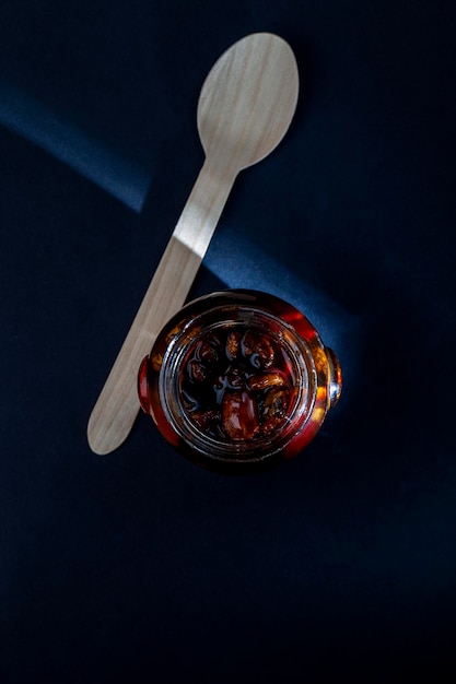 Sweet bee honey in a transparent glass jar