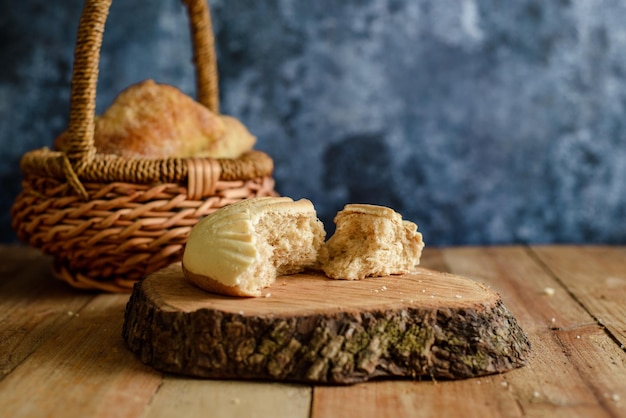 Sweet bread cut by hand on a wooden table.