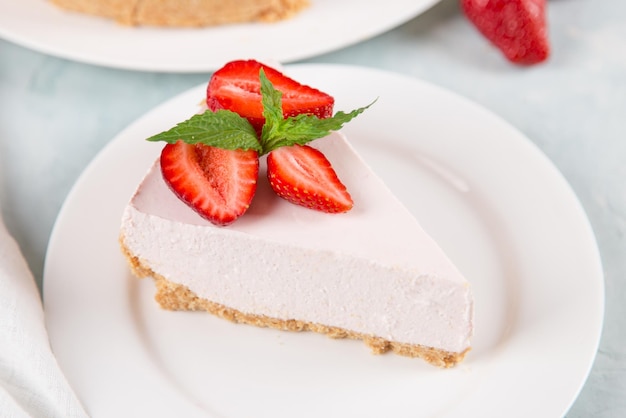 Sweet breakfast delicious cheesecake with fresh strawberries and mint homemade recipe without baking on a blue stone table Copy space