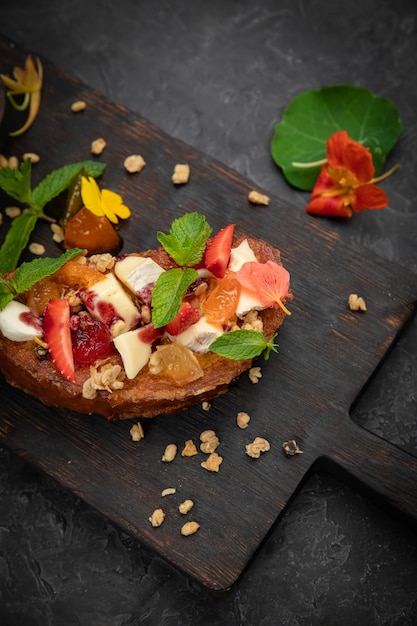  sweet bruschetta with cheese, strawberries, jam and mint 