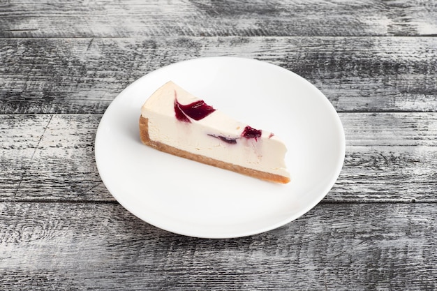 Sweet cake dessert on a wooden white background