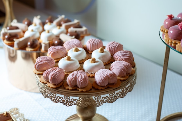 Sweet cakes at a wedding buffet Catering