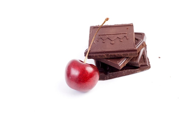 Sweet chocolate with red cherry isolated at white background