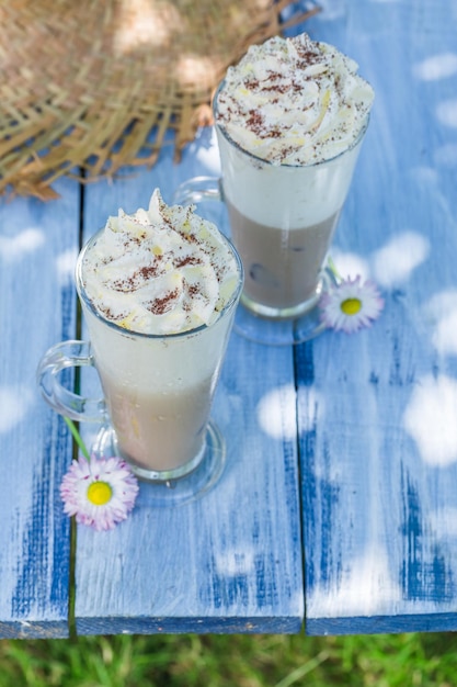 Sweet coffee with cream in sunny day