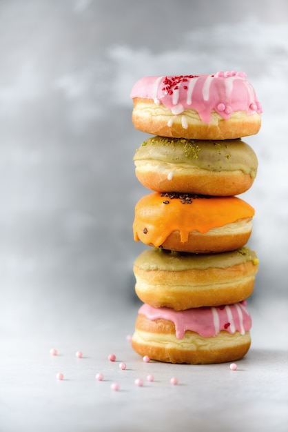 Sweet and colourful doughnuts on grey