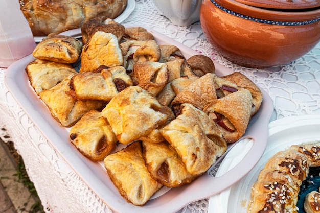 Sweet cookies with apple jam filling in plate on the table