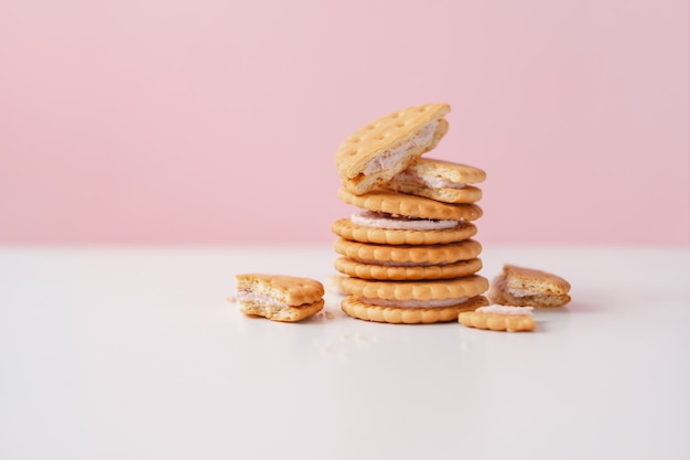 Sweet creamy filling crackers on a white pink pastel background