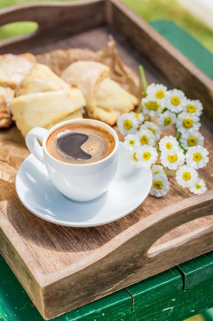 Sweet croissant and hot coffee for breakfast