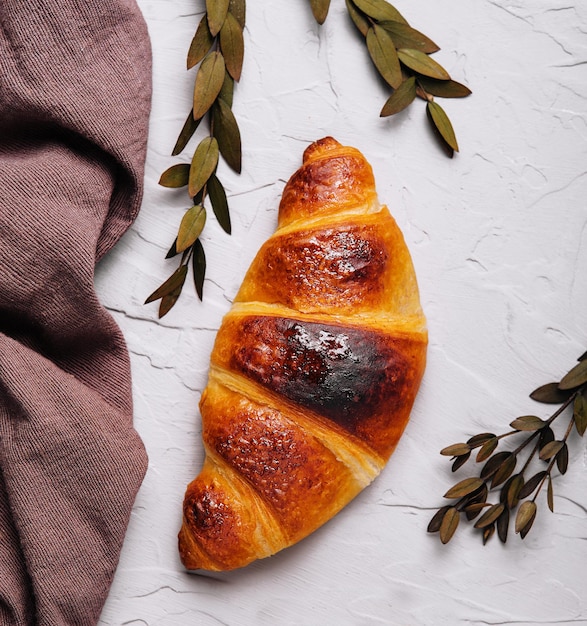 Sweet croissant and a linen towel