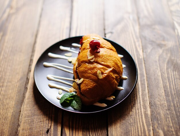 Sweet croissant on the wooden table