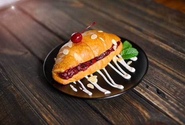 Sweet croissant on the wooden table