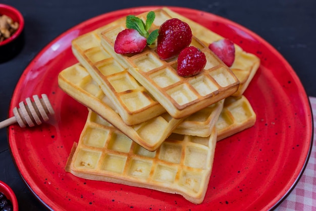 sweet dessert Belgian waffles with strawberries on a plate