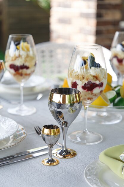 Sweet Dessert in big glasses on table served for wedding banquet