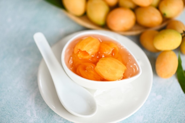 Sweet dessert marian plum fruit on bowl for food and wooden background tropical fruit Name in Thailand sweet Yellow Marian Plum Maprang Plango or Mayong chid