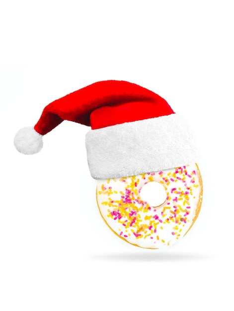 Sweet donut with christmas cap on white background. Concept December Santa Claus food.