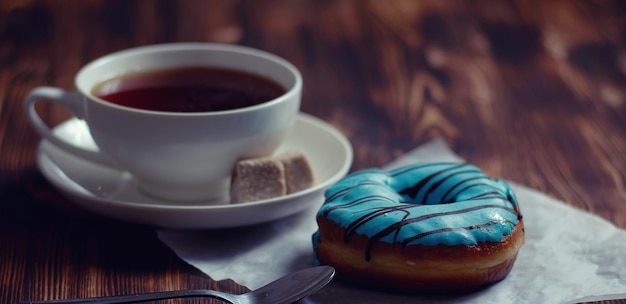 Sweet donuts on a dessert and a cup of tea