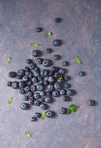 Sweet fresh blueberries on dark concrete background. Top view and copy space image