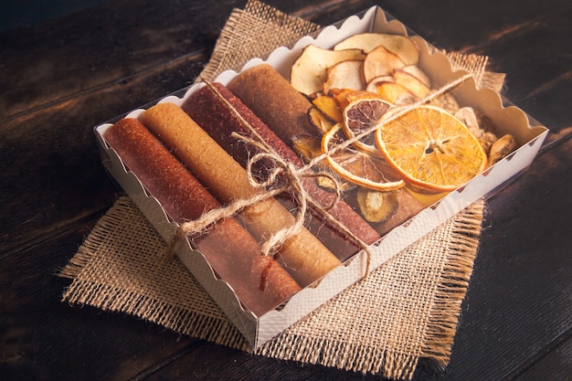 Sweet fruit snacks in a gift box - pastilles and dried fruit.