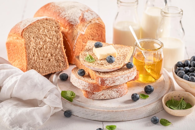 Sweet and homemade bread with berries maple syrup and butter