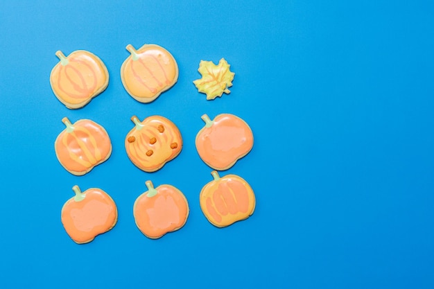 Sweet homemade cookie with icing on dark blue background flat lay composition