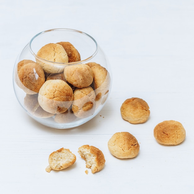 Sweet homemade cookies in glass bowl on white background, closeup