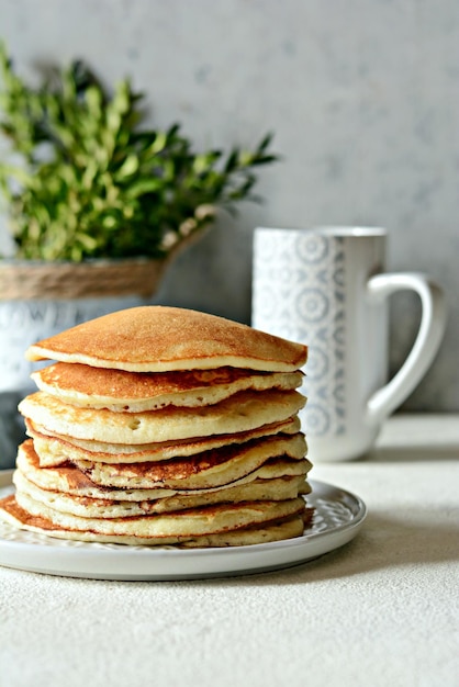 Sweet Homemade Stack of Pancakes with honey for Breakfast