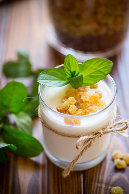 Sweet homemade yogurt with raisins in a glass