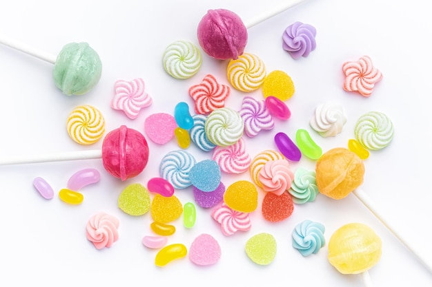 Sweet lollipops and candies on white background