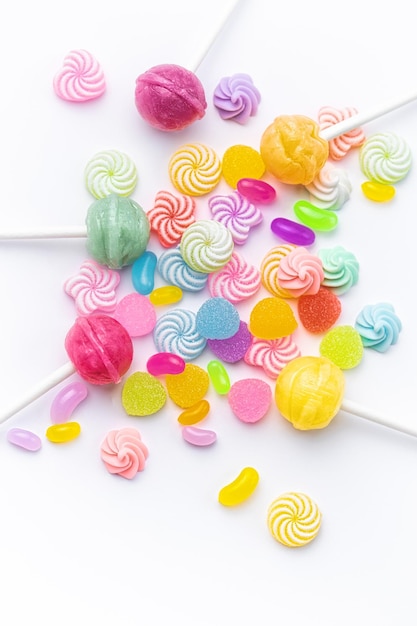 Sweet lollipops and candies on white background