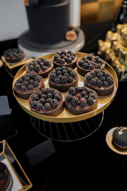 Sweet luxury candy bar on table in restaurant in black tone Cakes and other sweets