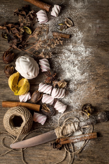 Sweet marshmallow pieces with different ingredients on wooden background. Top view. Copy space