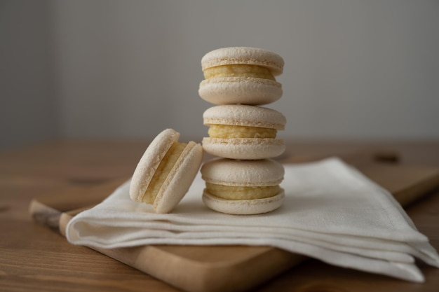 Sweet multicolored macaroons on a wooden background Delicious multicolored macaroons Highquality