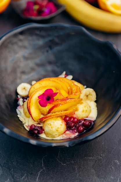 Sweet oatmeal with fried cheese balls peach and cranberries Healthy breakfast