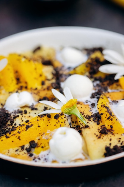 Sweet pancakes with ice cream chocolate and orange served on white plate Healthy and tasty breakfast